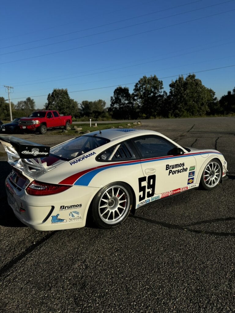 White Porsche 997 Cup race car with Brumos Porsche livery and number 59.