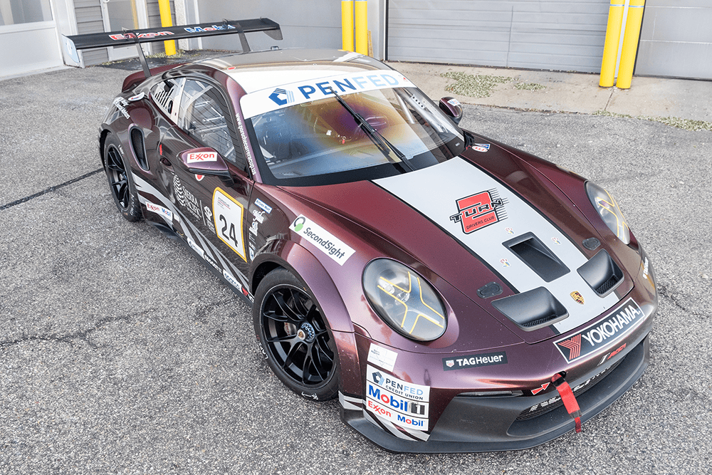 Kellymoss Porsche 911 GT3 Cup race car with sponsor decals and racing number 24.