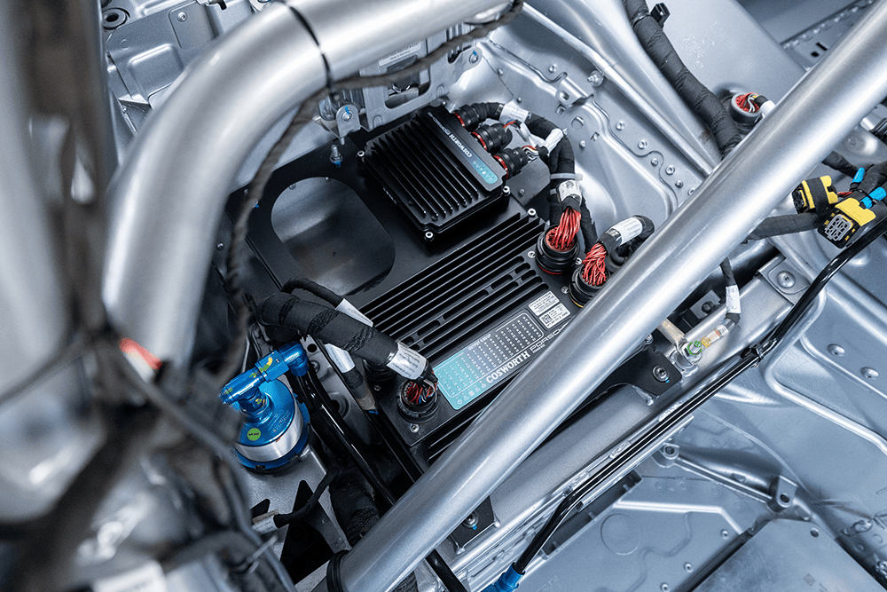 Close-up of racing car electronics and wiring in a high-performance vehicle.