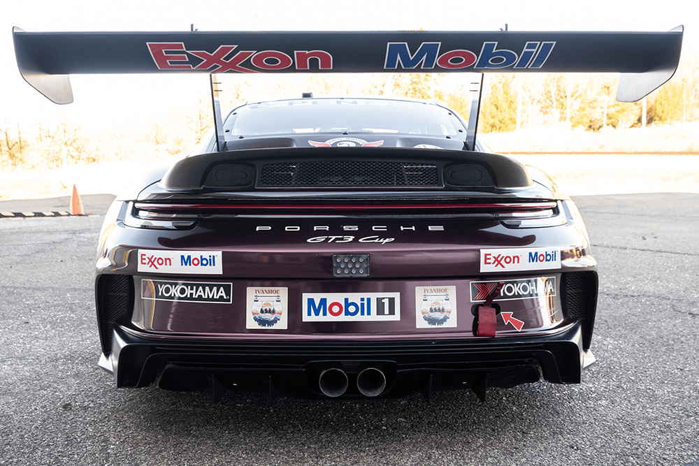 Rear view of a Porsche 911 GT3 Cup race car with sponsor decals.