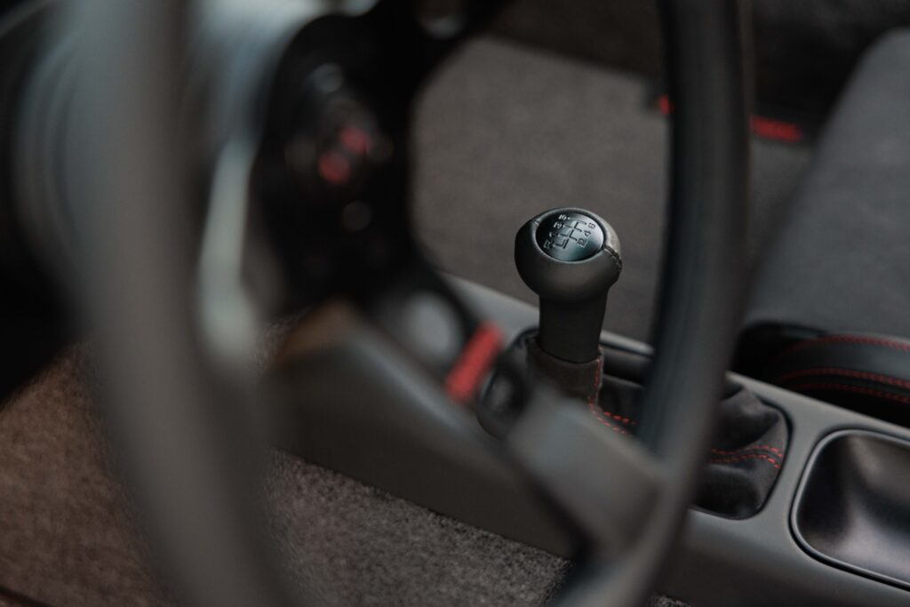 Close-up of manual gear shift in a 1989 Porsche 964 Ronin.