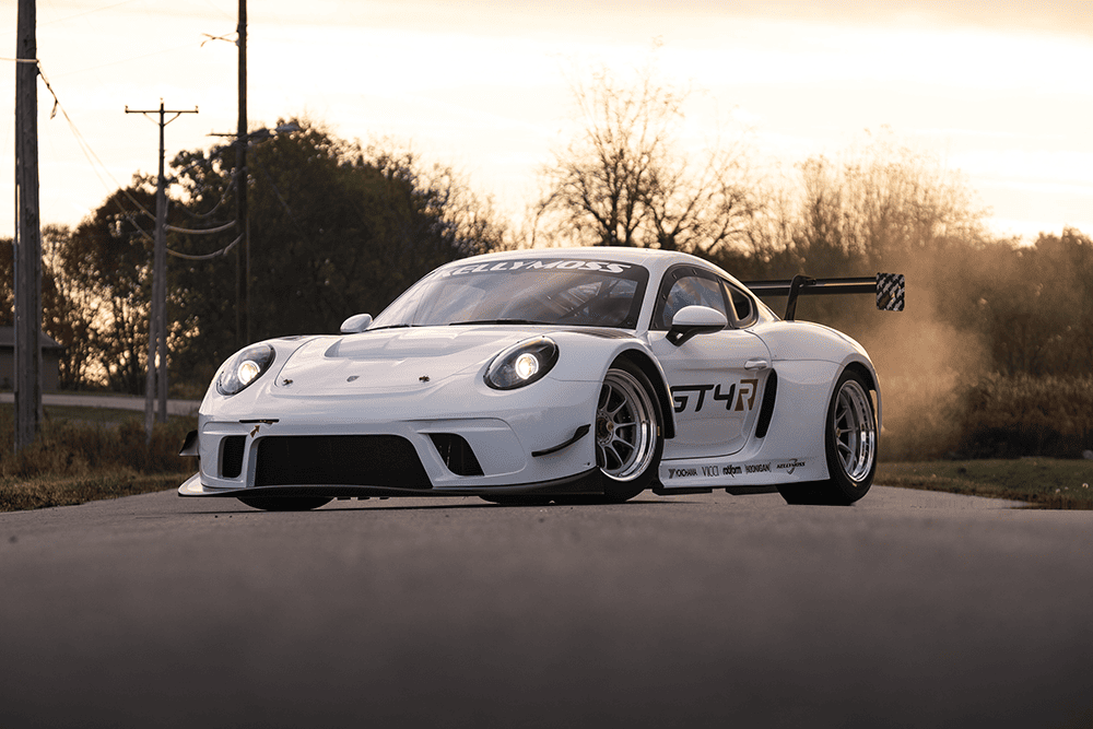 Kellymoss GT4R race car on track with sunset background.