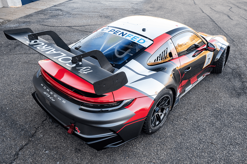 2022 Porsche 911 GT3 Cup 992 race car on track with aerodynamic features.