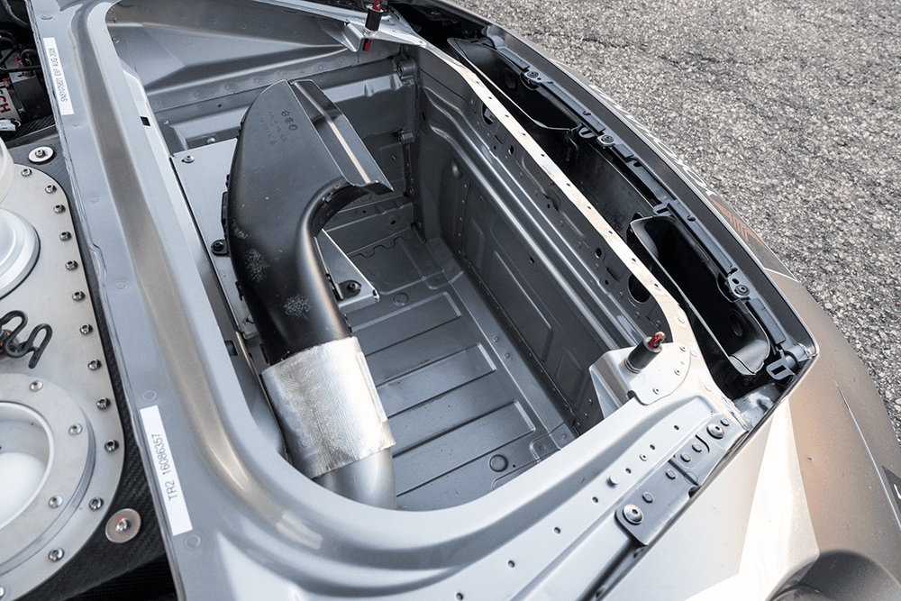 Close-up of the engine bay of a 2022 Porsche 911 GT3 Cup 992 race car.