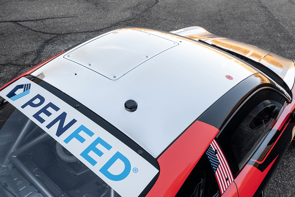 Close-up of Kellymoss Porsche 911 GT3 Cup 992 race car with sponsor decals.