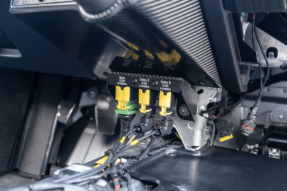 Close-up of Porsche 911 GT3 Cup 992 engine parts and wiring.