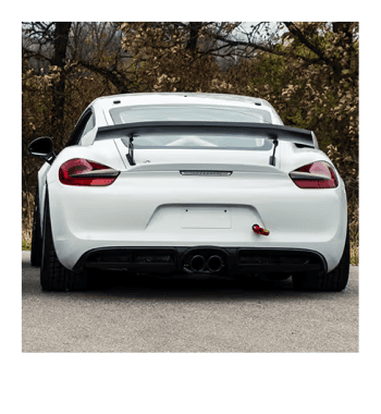 White Porsche GT4R sports car with rear spoiler and dual exhausts.