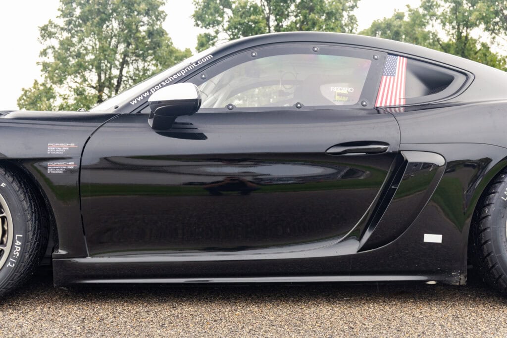 Black 2025 GT4 Clubsport RS race car with American flag decal.