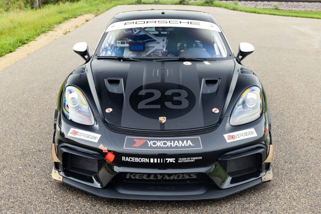 Black Porsche 718 Cayman GT4 RS with racing decals and number 23.