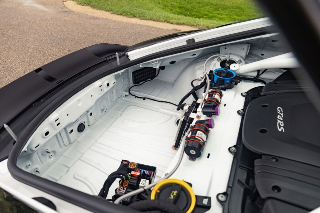Close-up of the interior of a Kellymoss 2025 GT4 Clubsport RS race car showing wiring and components.