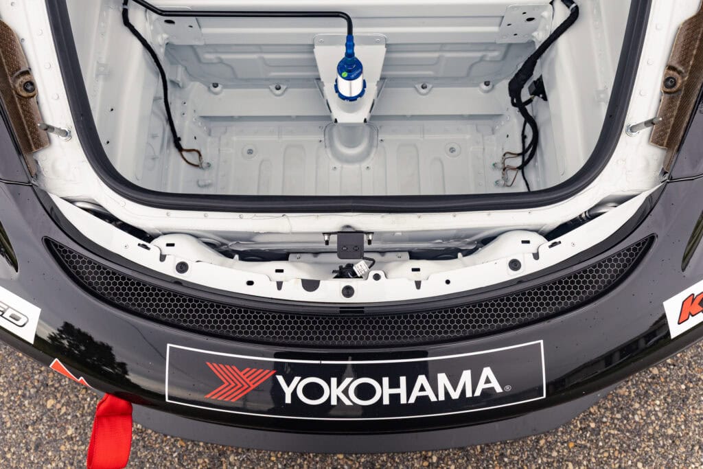 Yokohama logo on front of race car with open hood showing storage compartment.