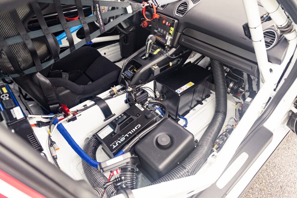 Interior of a Kellymoss 2025 GT4 Clubsport RS race car showing dashboard and safety features.
