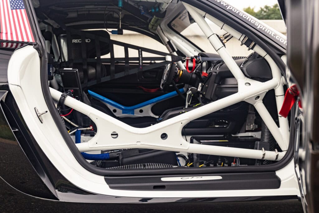Interior of the 2025 GT4 Clubsport RS by Kellymoss with racing seat and roll cage.
