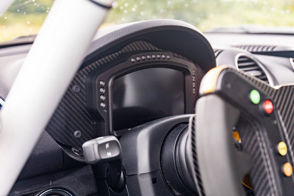 Close-up of racing car dashboard and steering wheel at Kellymoss.