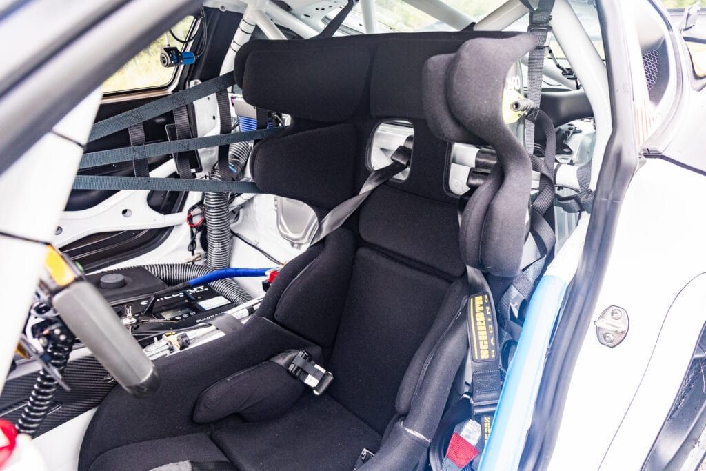 Racing car interior with racing seat and safety harness for 2025 GT4 Clubsport RS.