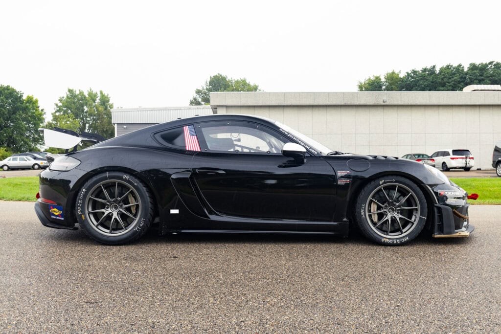 Black 2025 GT4 Clubsport RS race car parked outdoors.