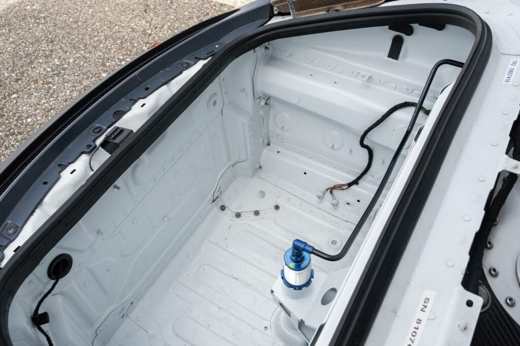 Interior of a race car trunk with water system components.