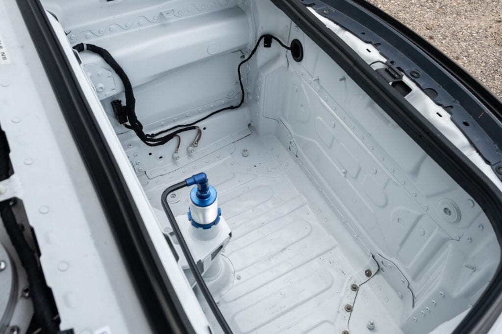 Interior of a Kellymoss 2023 GT4 Clubsport RS showing stripped-down trunk area.