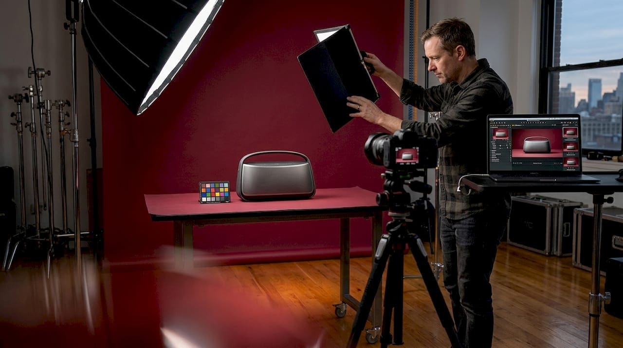 Photographer setting up product shoot in studio