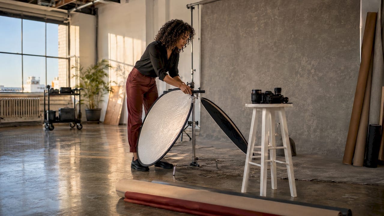 Photographer setting up lighting in Manhattan studio