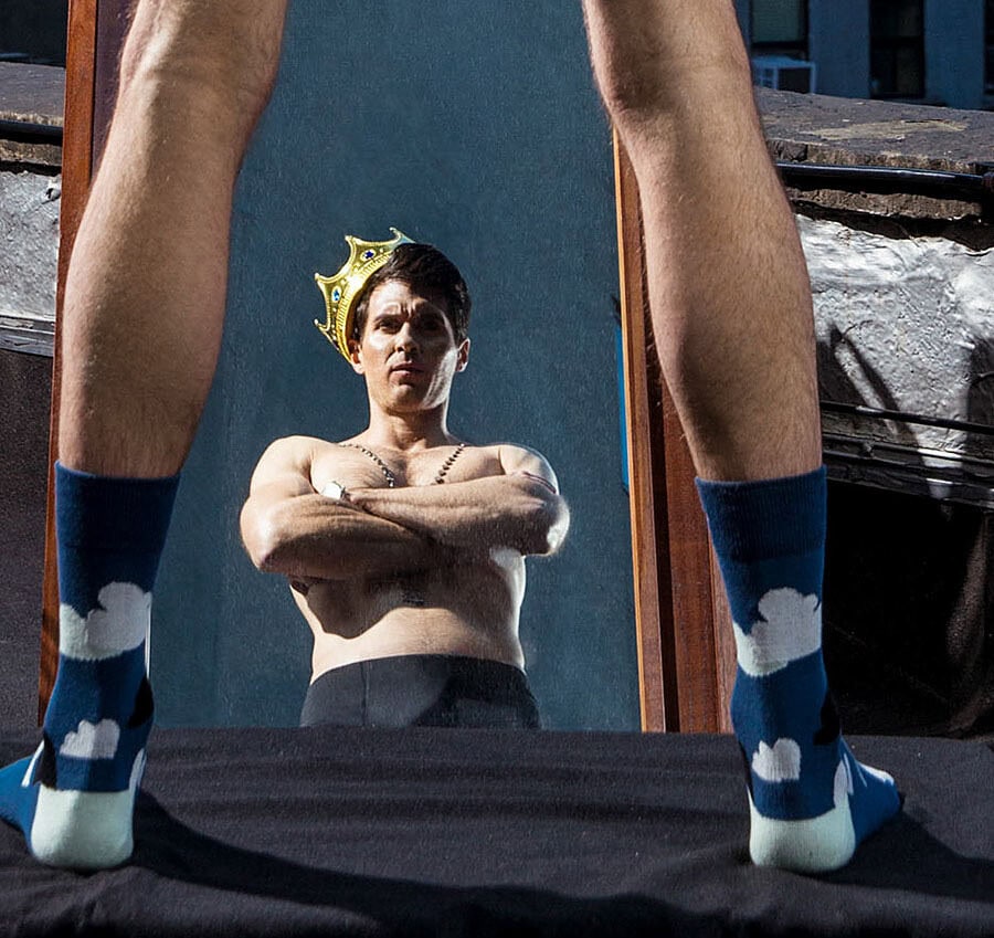 Fashion photo inspired by fairy tales with a woman wearing a crown and socks.