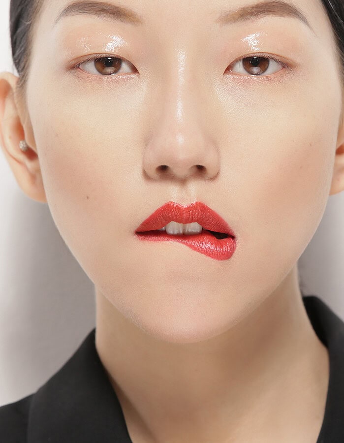 Close-up portrait of a woman with bold red lipstick and minimal makeup. photographer NYC