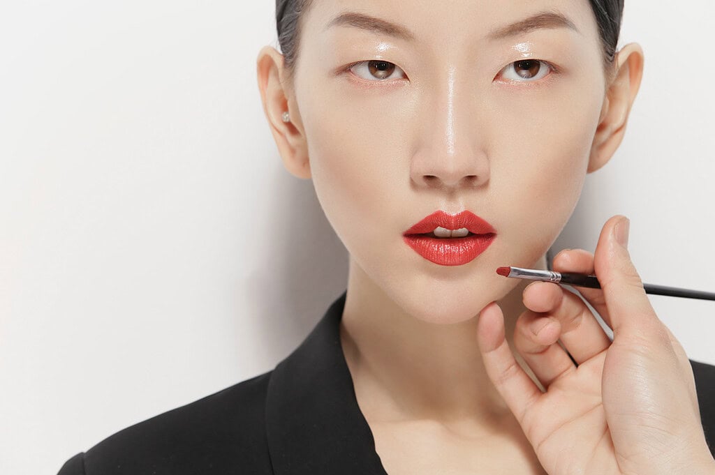 Close-up of a woman getting her makeup done with a brush. photographer NYC