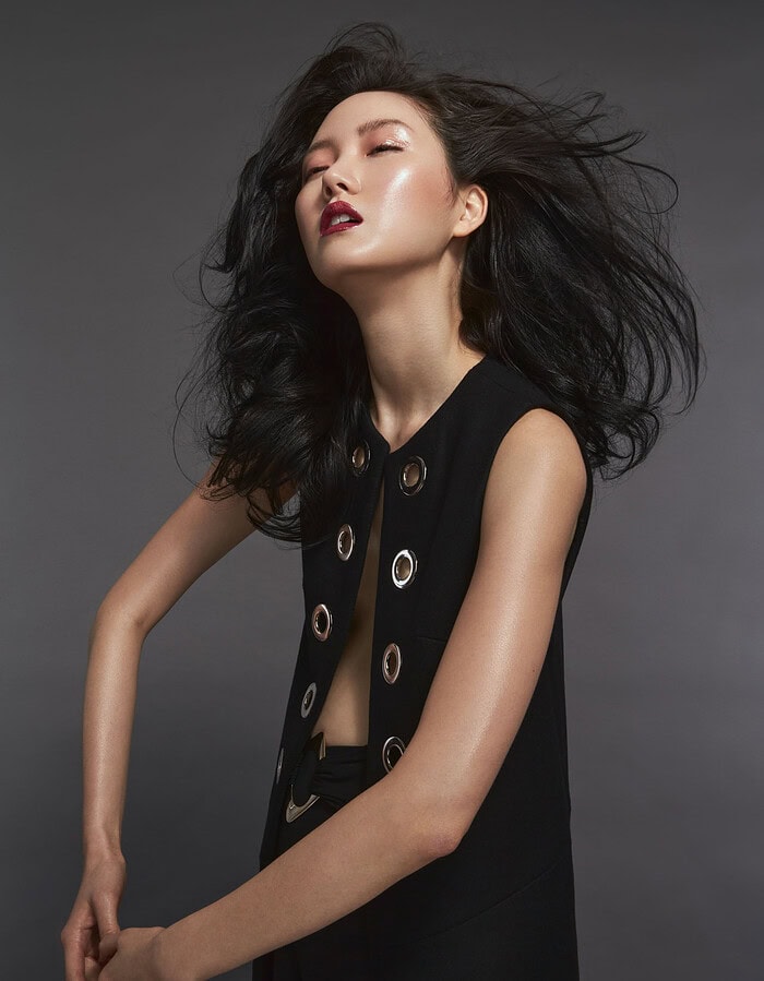 Fashion portrait of a woman with flowing black hair and bold makeup. photographer NYC