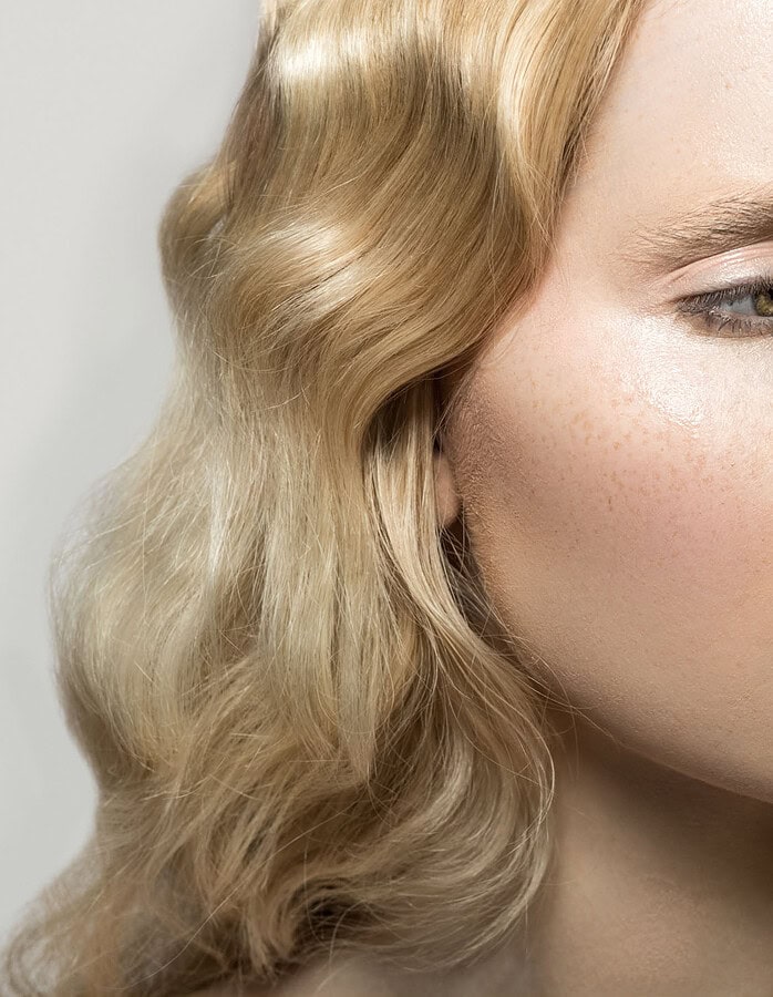 Close-up of a young woman with blonde wavy hair and natural makeup. photographer NYC