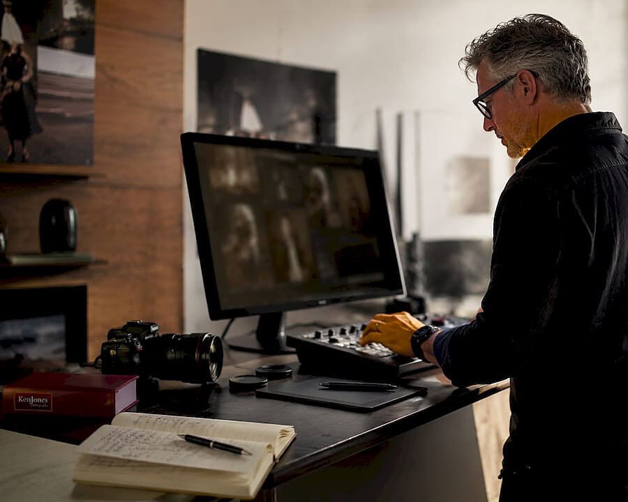 Experienced photographer editing photos in NYC studio