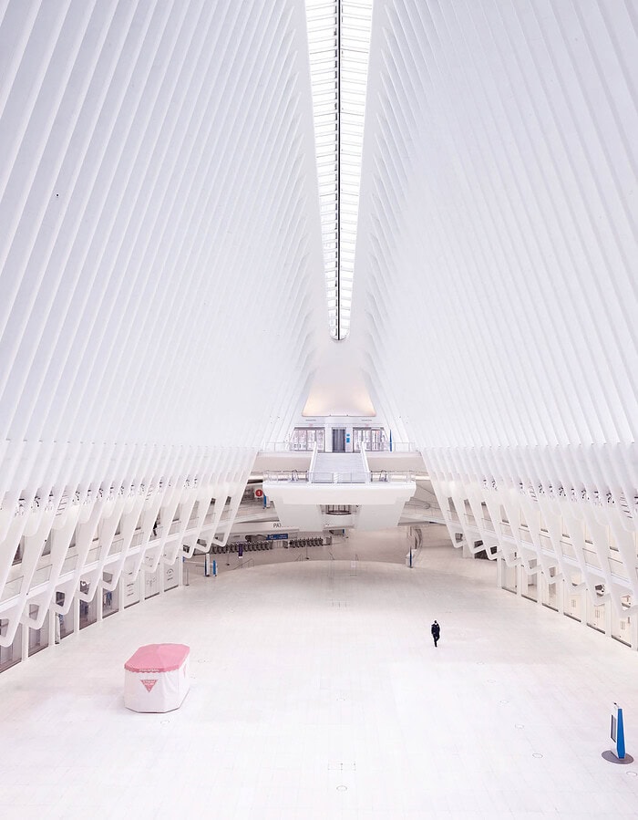 Nearly empty World Trade Center Oculus main floor with one person visible during COVID.