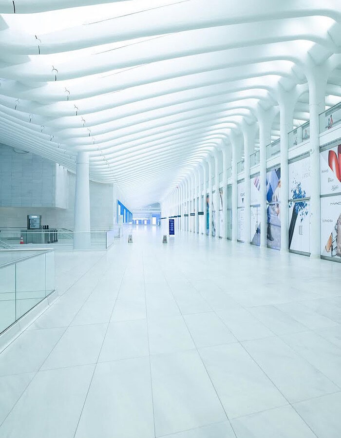 Bright empty white corridor inside the World Trade Center Oculus during COVID.
