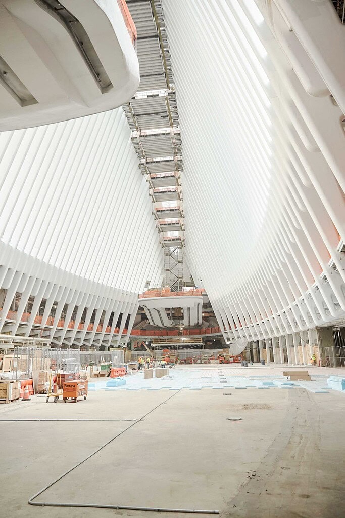 World Trade Center Oculus interior under construction with white ribs, scaffolding and unfinished floor.