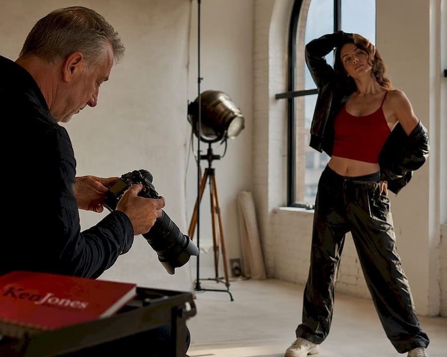 Photographer adjusting lights during composite studio shoot