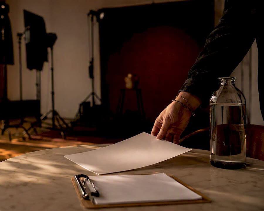 Producer placing pre-production checklist on table