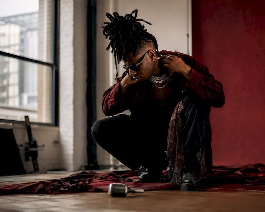 Music artist adjusting accessory during studio shoot