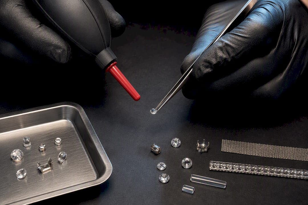 Tweezers and blower beside reflective product details