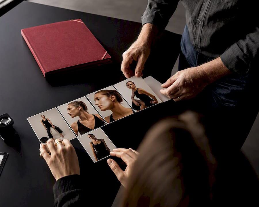 Photographer and client reviewing proof prints