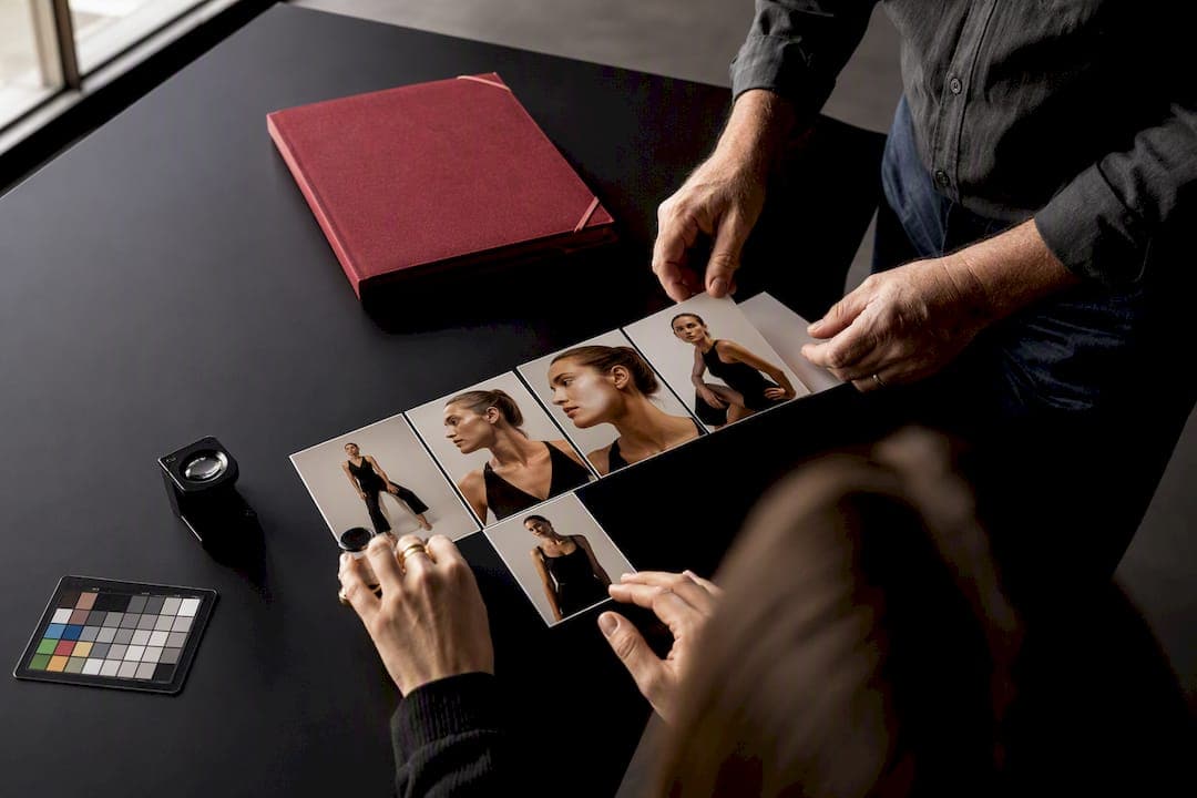Photographer and client reviewing proof prints