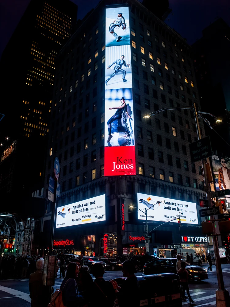 GMAT portrait campaign displayed on a vertical Times Square digital billboard