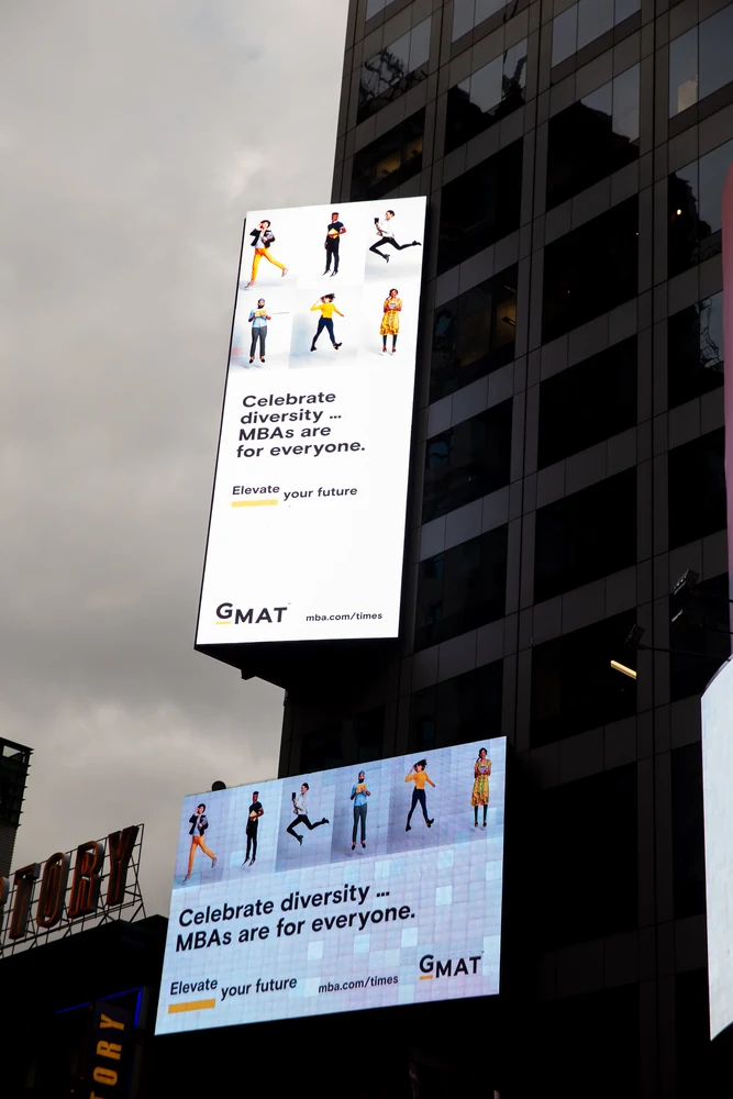 GMAT campaign imagery displayed on a large Times Square billboard in New York