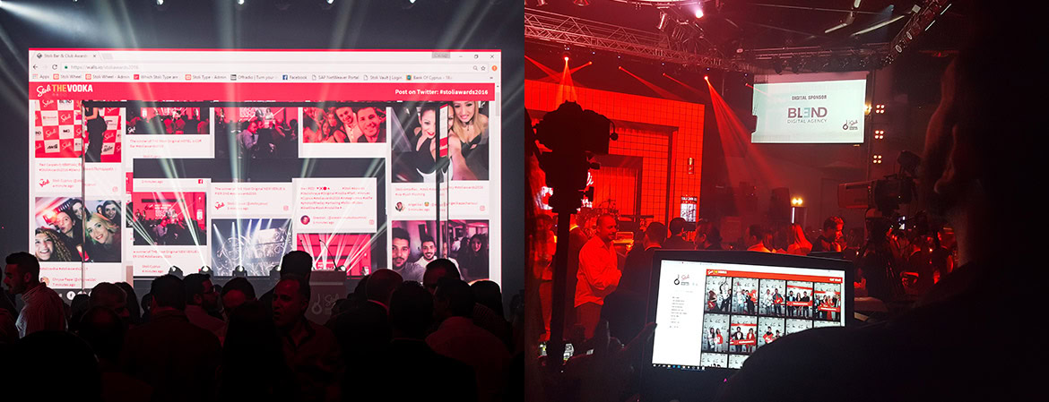 A large screen displays a social media feed at an event with a crowd and stage in the background.