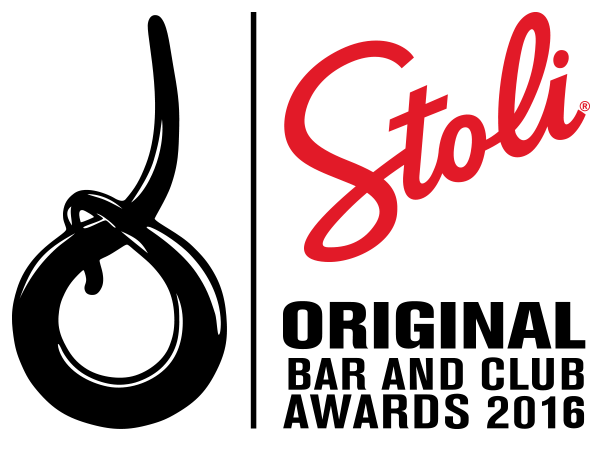 A colourful display of various fresh vegetables and herbs arranged on a wooden surface.