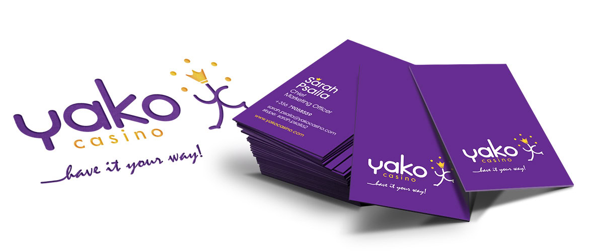 Yako Casino business cards with purple background and white logo, stacked on a white surface.