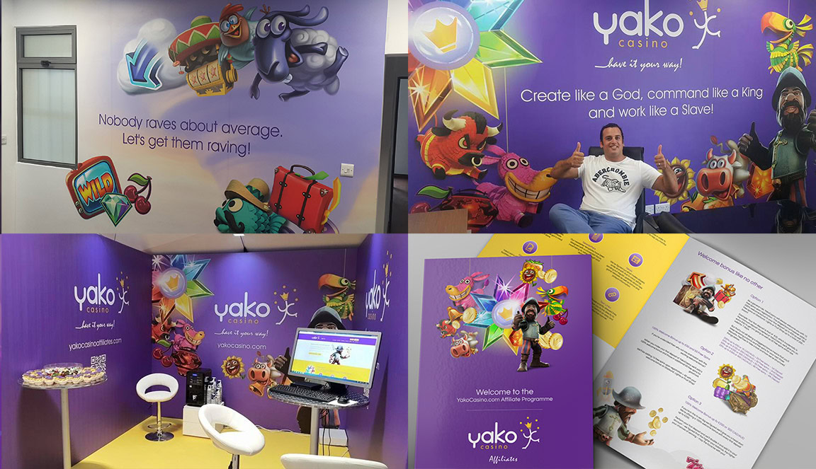 A colourful exhibition booth with cartoon characters, promotional banners, and printed brochures displayed on tables.