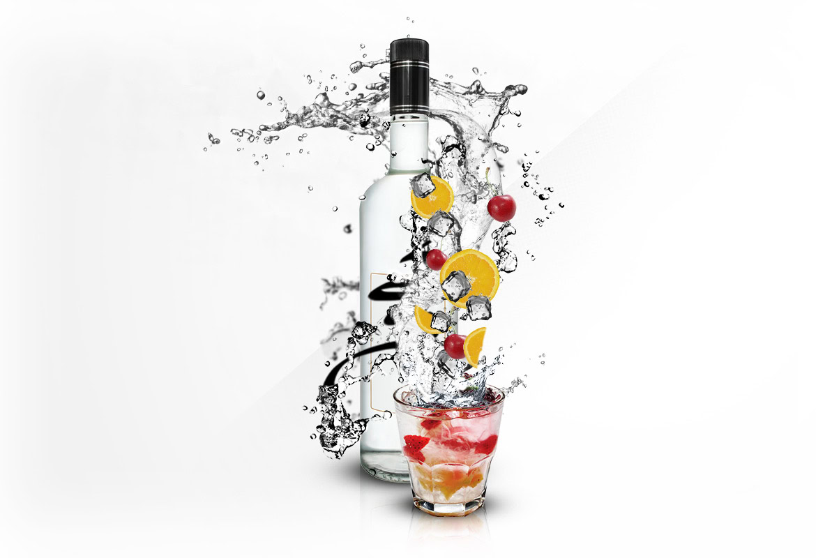 Bottle of clear spirit with fruit slices and ice, splashing into a glass with ice and fruit pieces.