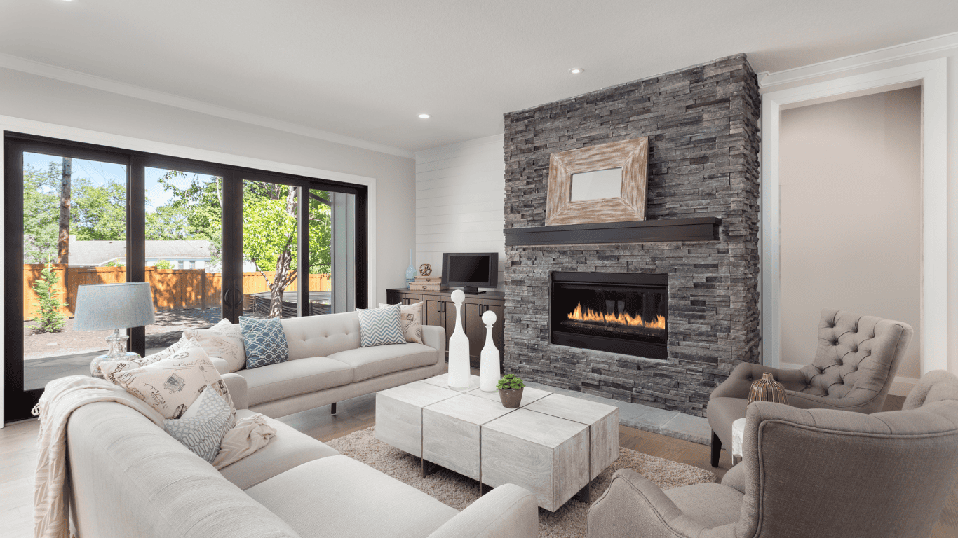 Contemporary living room featuring a sleek stone fireplace and large windows.