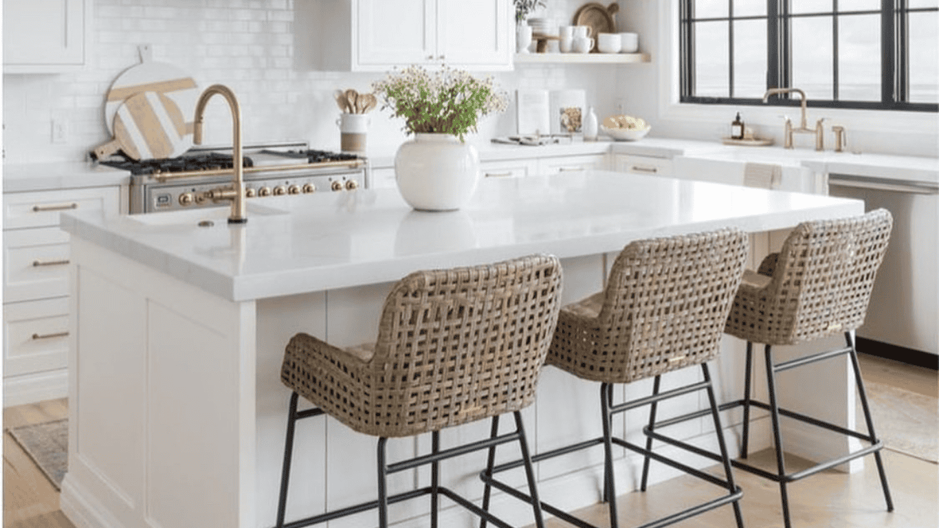 Contemporary kitchen with white cabinets, island, and wicker bar stools.