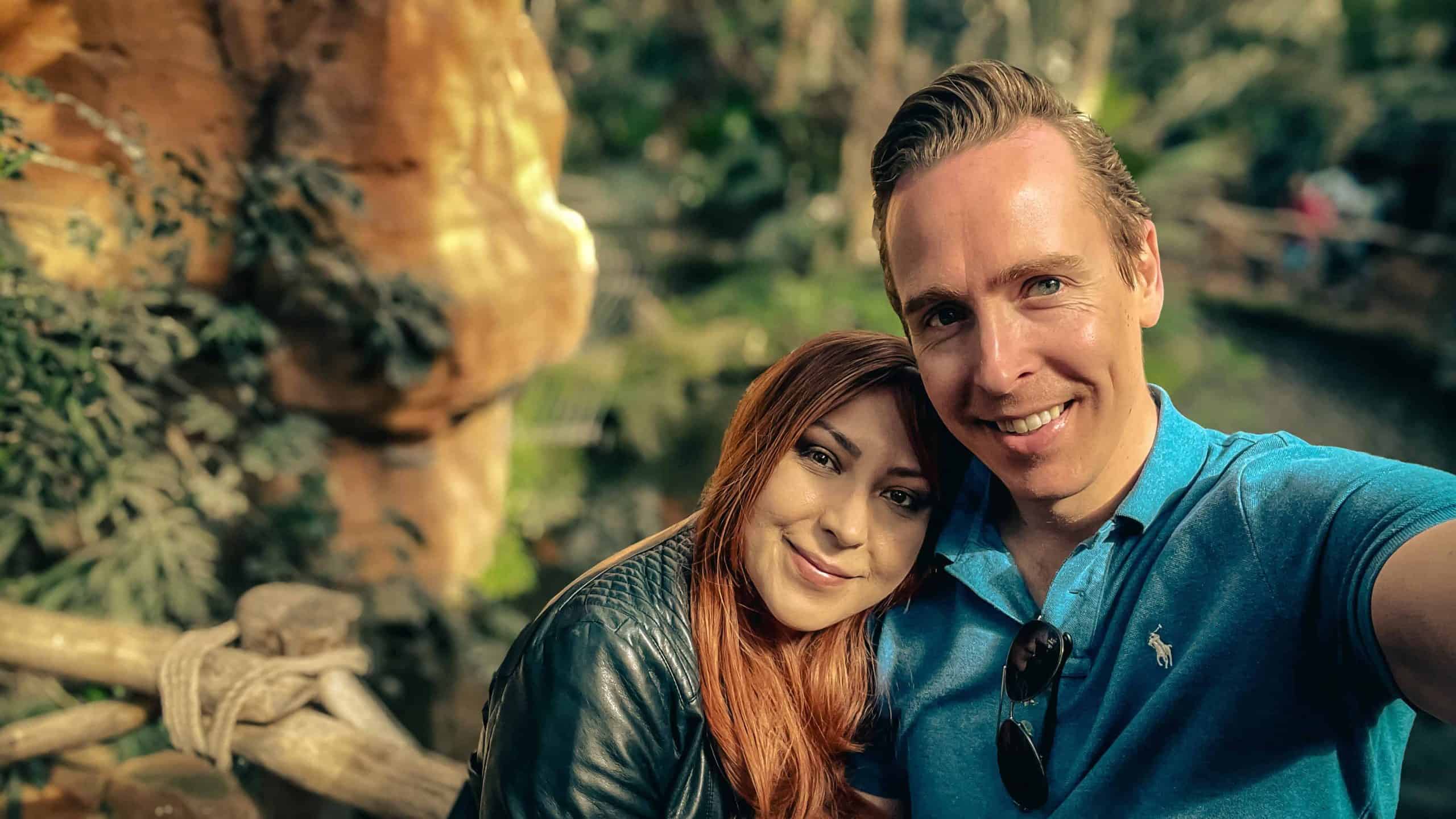 Happy couple enjoying a scenic outdoor setting in springtime.