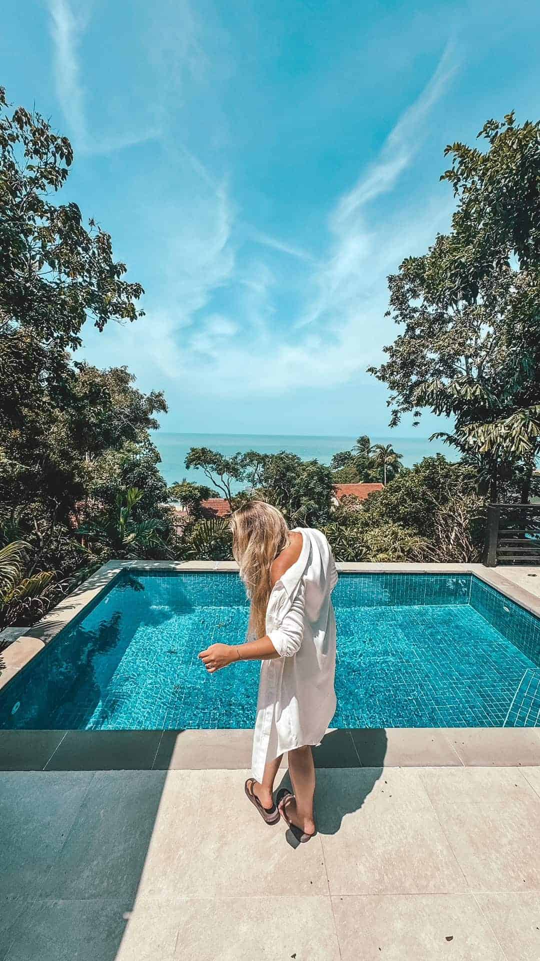 Luxury infinity pool overlooking tropical landscape and ocean in Koh Samui.